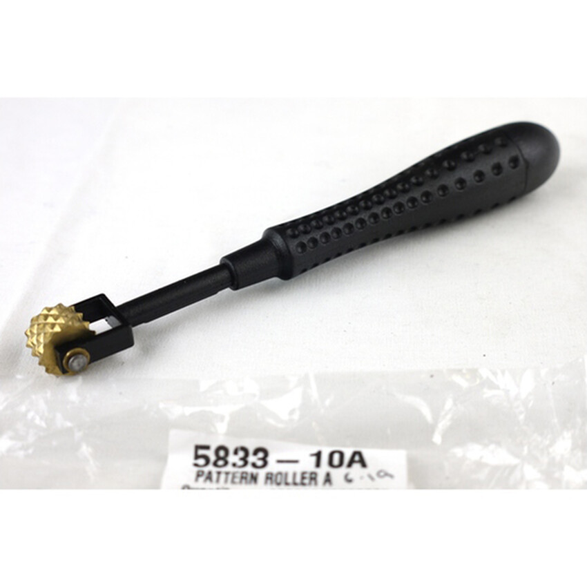 Photograph: Pattern Roller A: Plastic handle/brass head 16cm