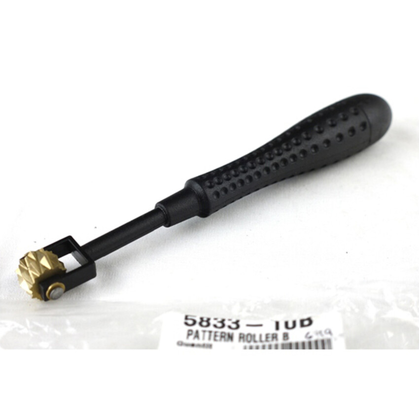 Photograph: Pattern Roller B: Plastic handle/brass head 16cm