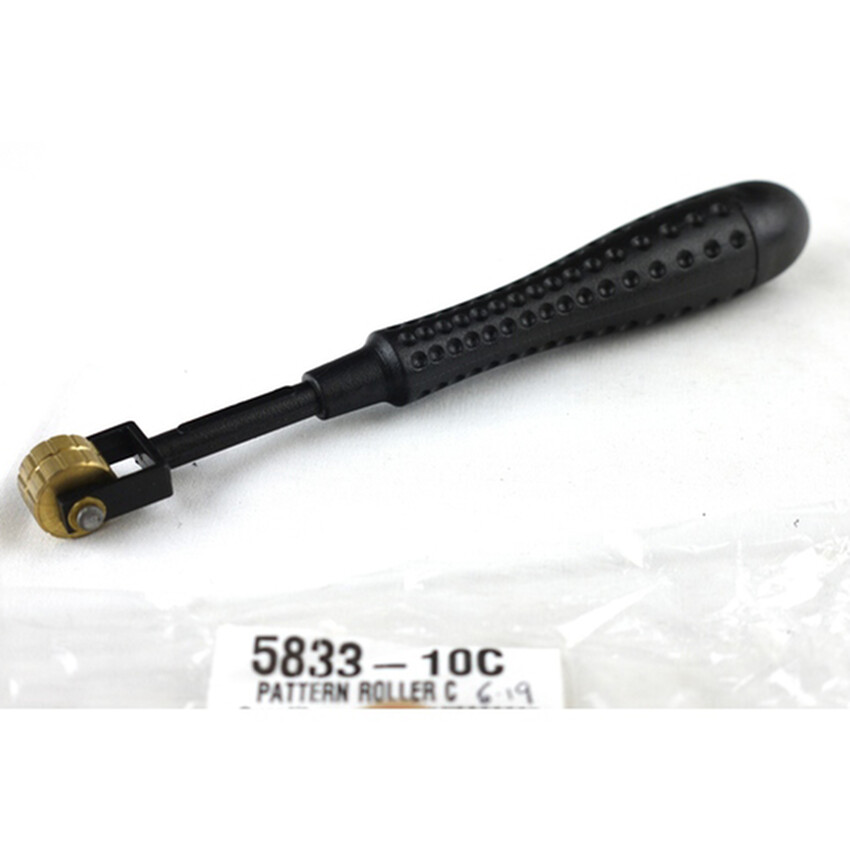 Photograph: Pattern Roller C: Plastic handle/brass head 16cm