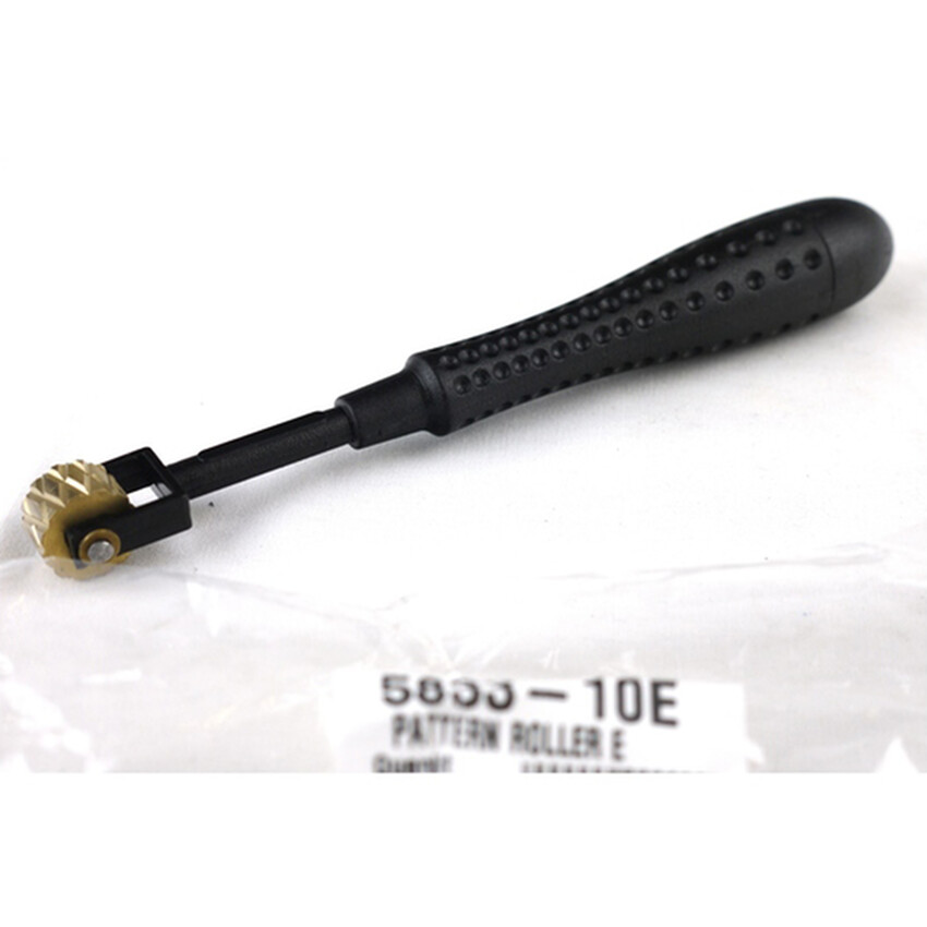 Photograph: Pattern Roller E: Plastic handle/brass head 16cm