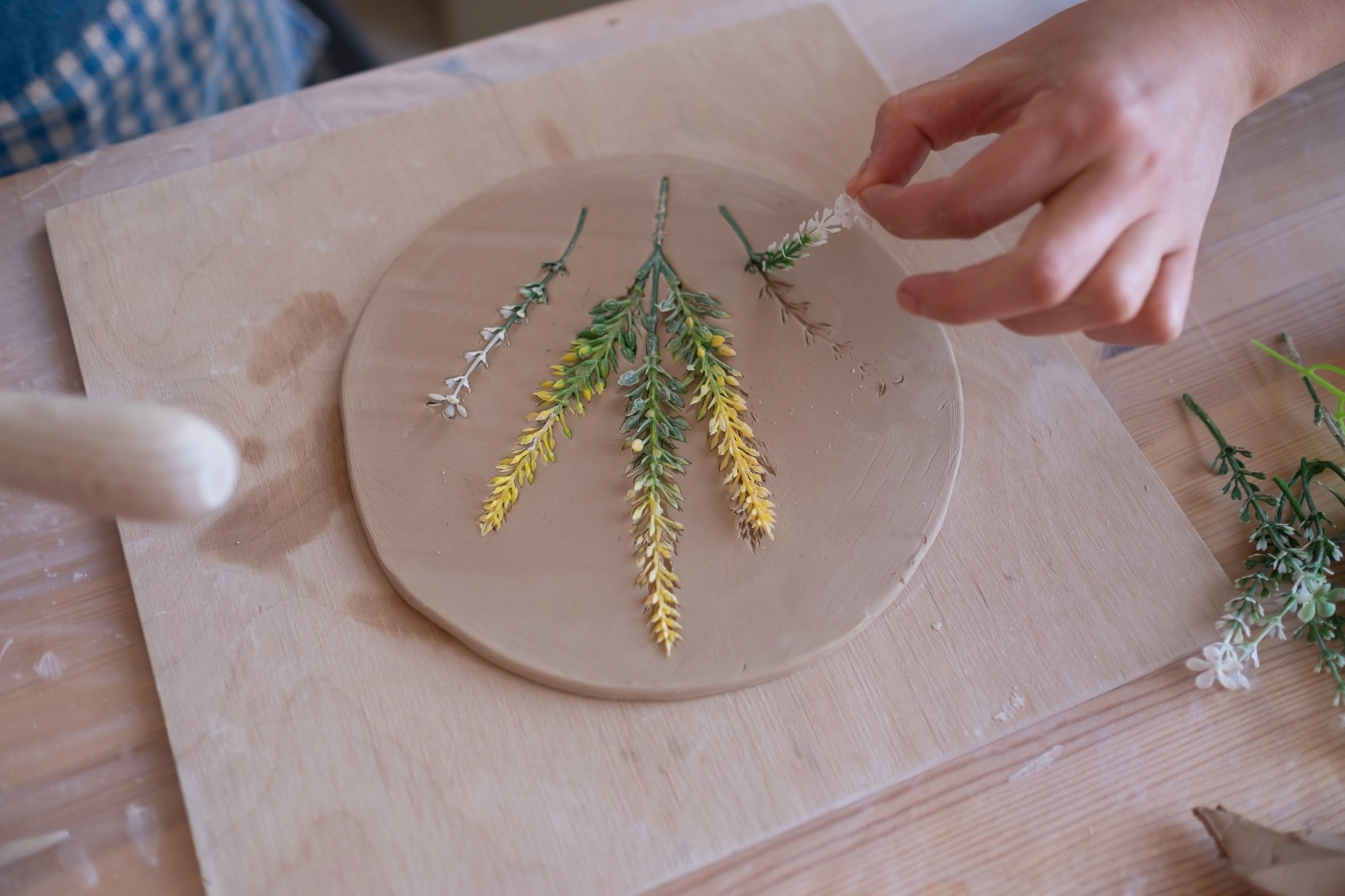 potter adding texture with plants
