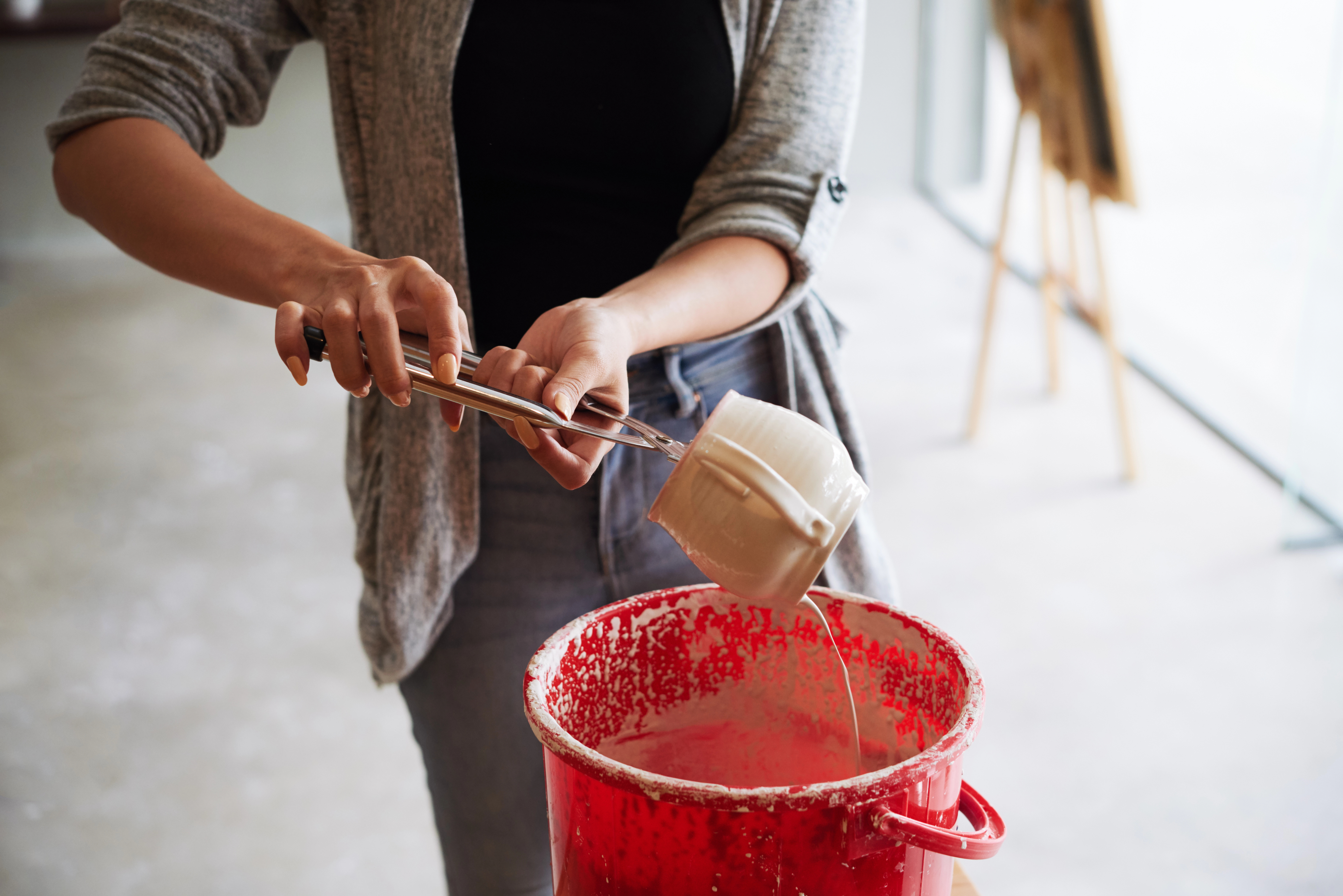 female potter glazing ware