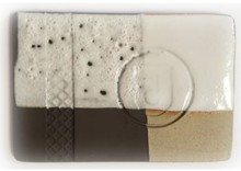 Test tile illustrating how the use of a barrier (slip layer) prevents outgassing problems in glazes used on Vulcan bodies 